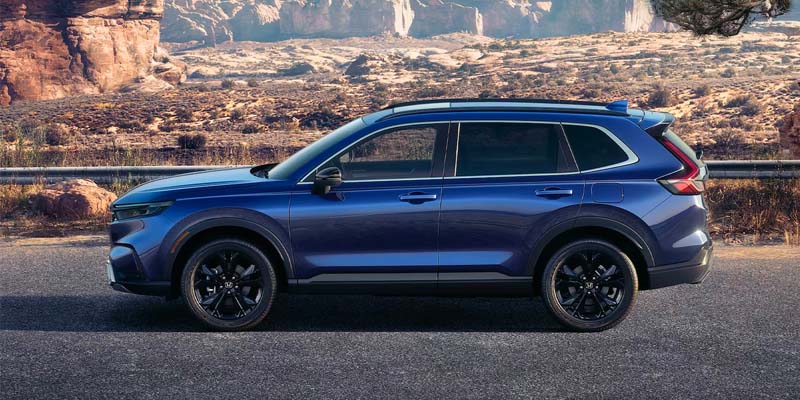 A side profile photo of a blue 2024 Honda CR-V Hybrid