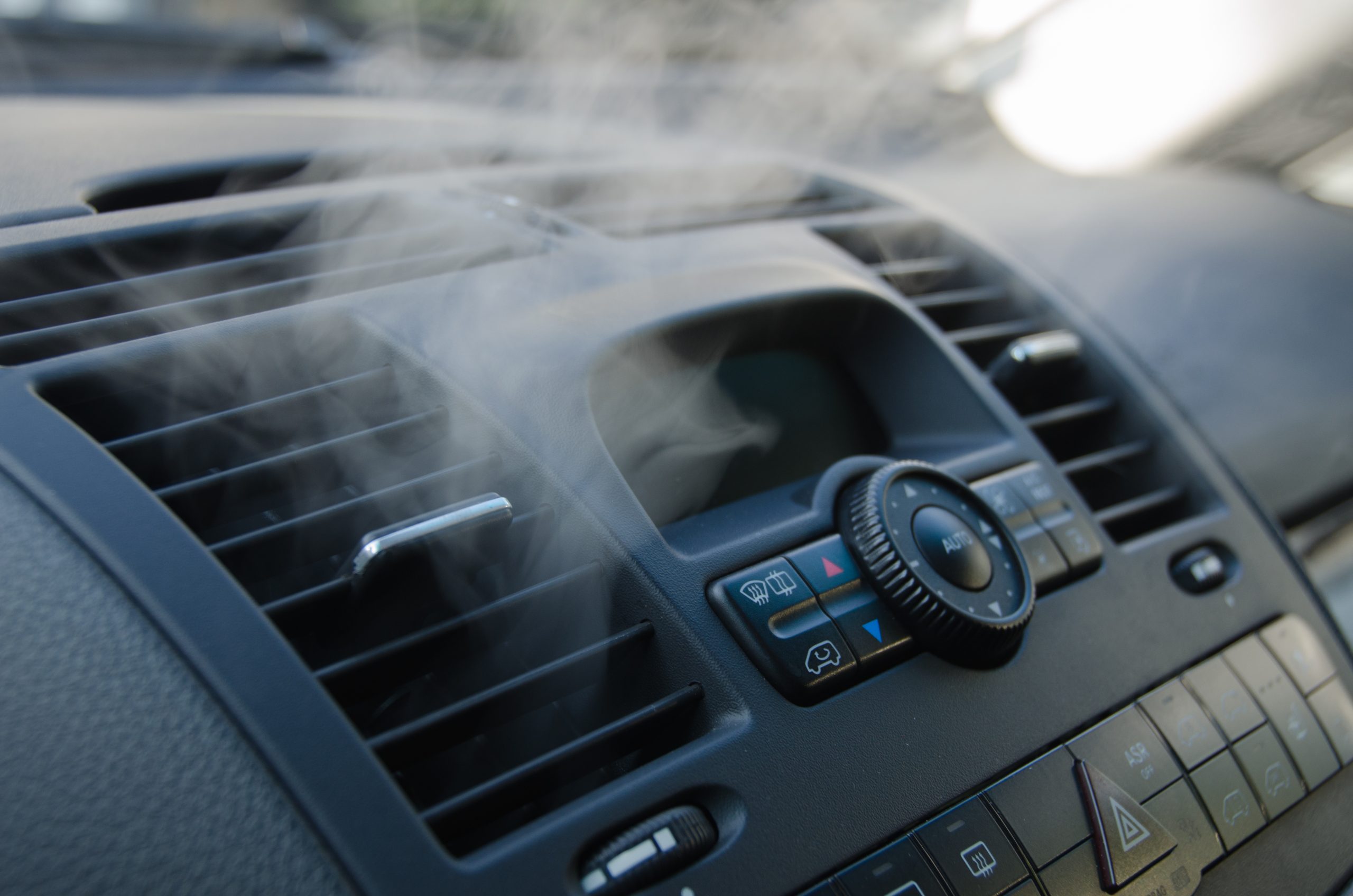 A photo of a car's AC vent steaming