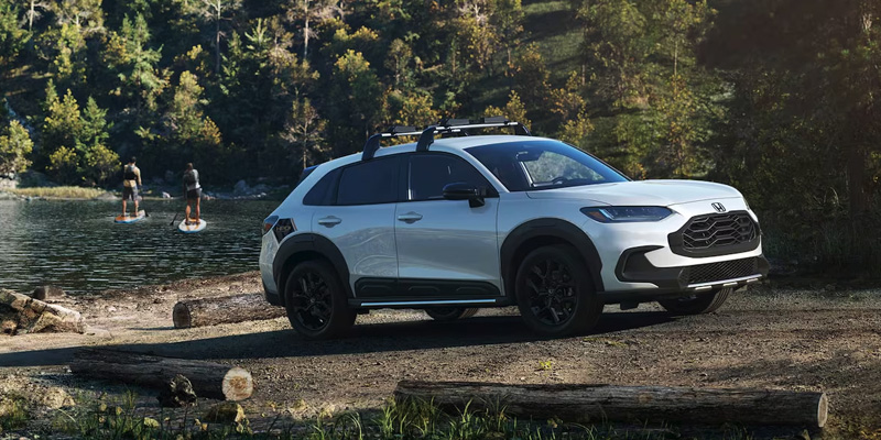 A photo of a white 2025 Honda HR-V parked near a boat ramp.