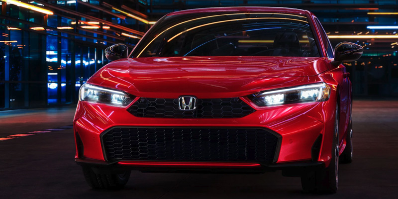 A photo of the front grille of a red 2025 Honda Civic Hybrid