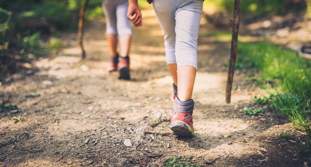A photo of two people's legs while hiking