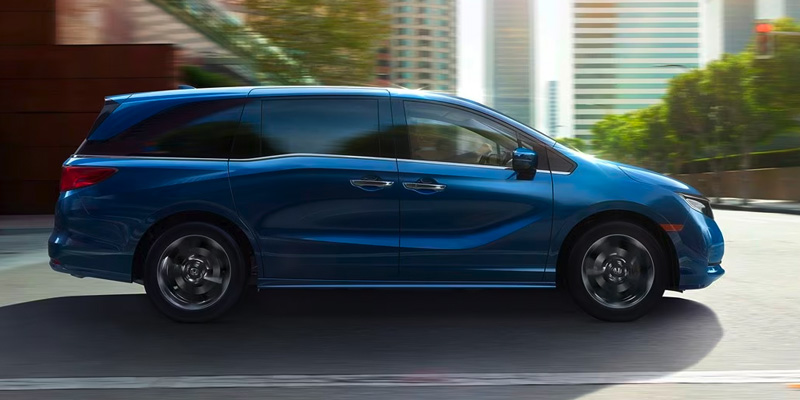 A side profile of a blue Honda Odyssey